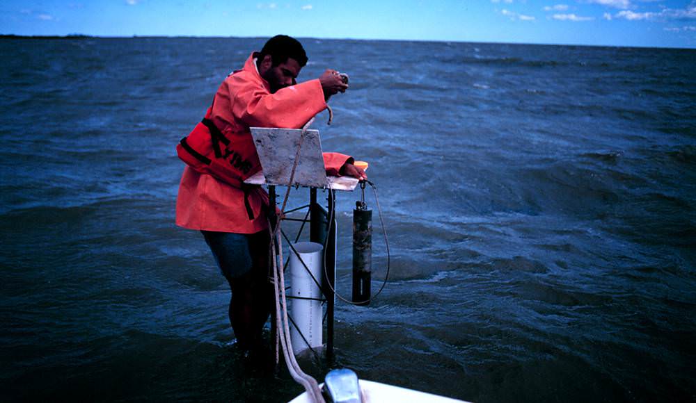 man standing on a offshore data-logger station