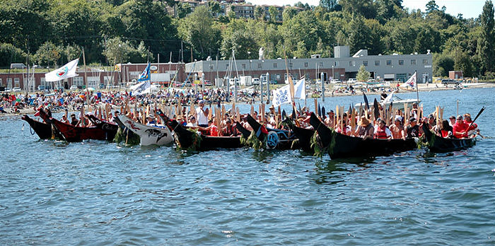 multiple canoes starting a group journey